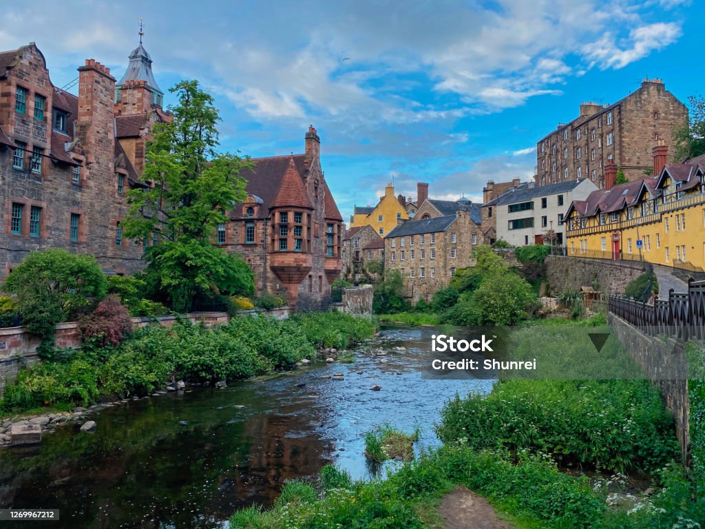 Dean Village, Edinburgh, Scotland Dean Village is a beautiful residential and small business area located in a valley along the Waters of Leith in Edinburgh. It is a popular tourist destination and features brightly coloured buildings in the Scottish Baronial Style. Midlothian - Scotland Stock Photo