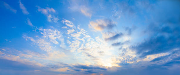 istock Blue sky clouds background. Beautiful landscape with clouds and orange sun on skysky 1269970491