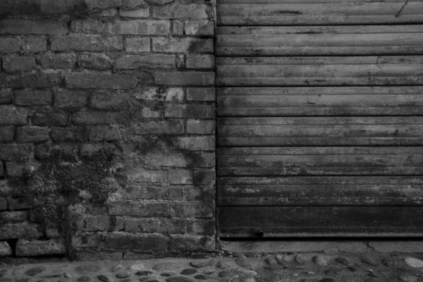 istock A metallic garage door next to a worn out brick wall 1269975622