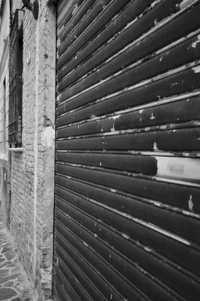 istock A metallic garage door next to a worn out brick wall 1269975631