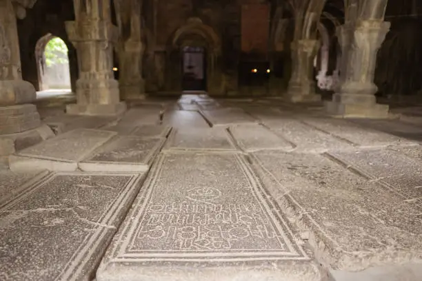 Photo of headstones on uneven ground in the interior of old Sanahin Armenian Monastery of the Armenian Apostolic Church