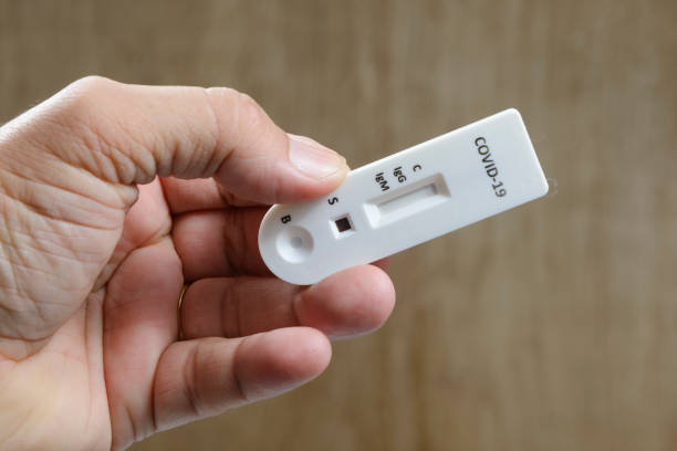 istock man holding his covid-19 test 1269983245