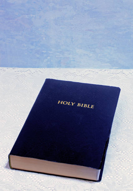 istock Black Bible on white lace with blue copy space 1269989265