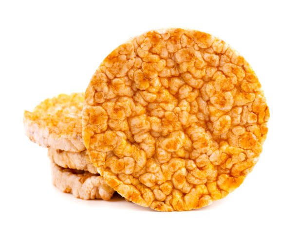 istock Caramelized rice-corn crispbread, isolated on white background. Sweet puffed whole grain crispbread. 1269989875