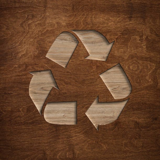Recycling arrows cycle symbol engraved in wooden board stock photo