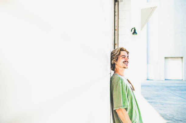 istock Millenial age guy laughing in candid image with copy space 1269990798