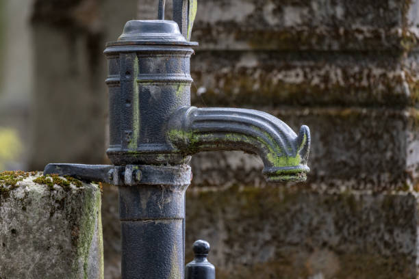 hand pump in a graveyard - cast in stone imagens e fotografias de stock