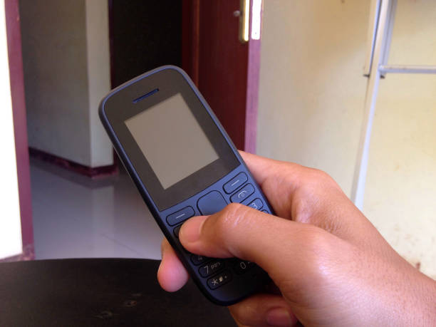 istock holding a cellphone in Indonesia 1269997129