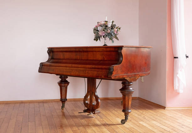 istock Large brown piano in a pink room 1269999387