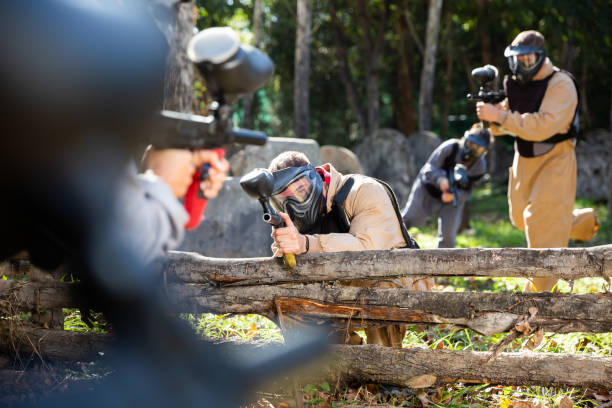 istock Paintball players aiming outdoors 1270002697