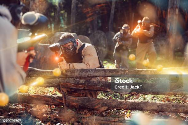 Men And Women Playing Paintball Stock Photo - Download Image Now - Paintballing, 30-34 Years, 35-39 Years