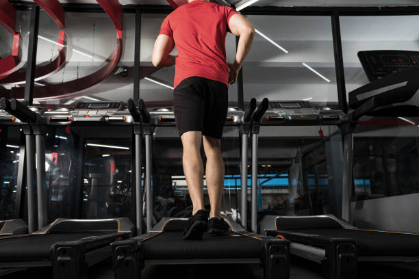 istock Athletic young man running in gym 1270004988