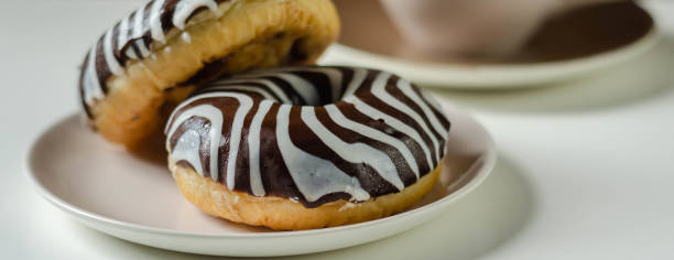 istock Doughnut with chocolate flavour filling, topped with white and black icing 1270007575