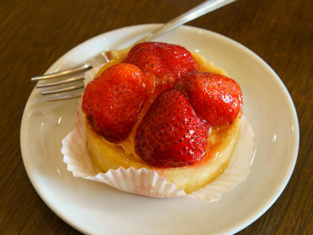 Photography of a delicious tartlet with strawberries. Theme how to get good mood at the morning. Breakfast concept.