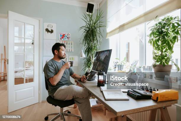 Digital Artist Contemplates During Coffee Break In His Home Office Stock Photo - Download Image Now