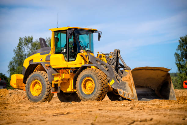 istock Yellow earth mover on a highway construction site 1270008718