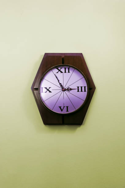 Old Stylish Clock Hanging On A Wall