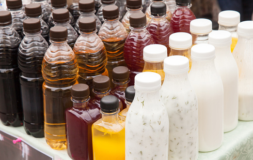 Assortment of natural soft drinks. Beer, fresh juice, kvass, cider and ayran are in plastic bottles
