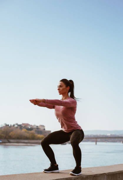 istock Beautiful young woman during the morning doing squad exercises, side view 1270014742