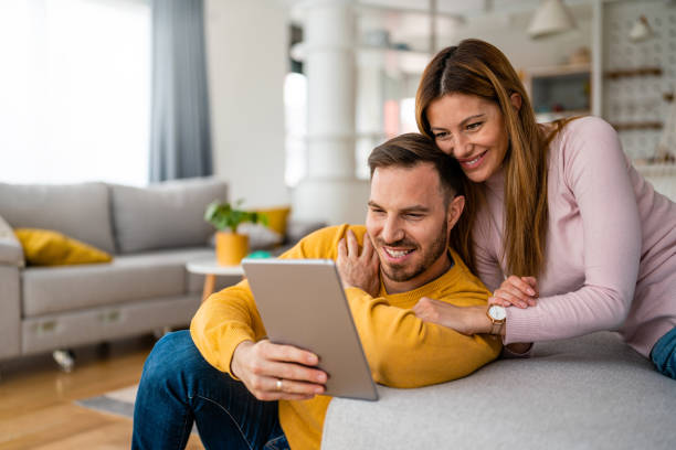 istock Couple in love using tablet computer at home and having fun 1270014797