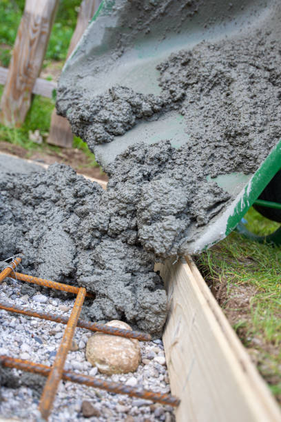 istock Pouring fresh cement into a hole in the ground in backyard 1270019718