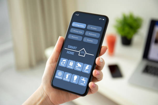 istock female hands holding phone with app smart home on screen 1270021035