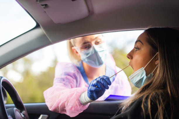 istock Drive Thru covid-19 testing with PPE medical staff Nose Swab 1270021158