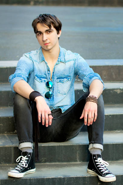 istock Young man sitting on the stairs 1270021606