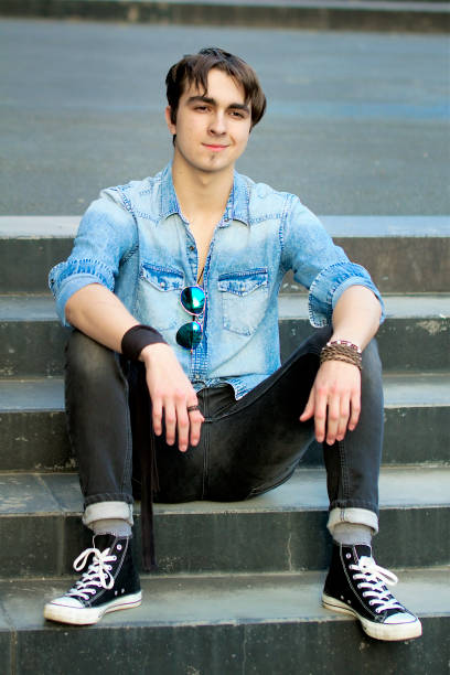 istock Young man sitting on the stairs 1270021649