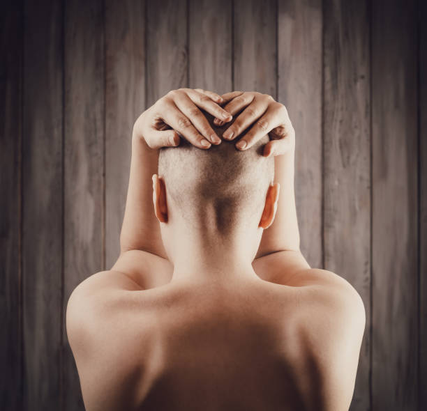 Portrait of a hairless woman from back Portrait of a hairless young woman from back completely bald stock pictures, royalty-free photos & images
