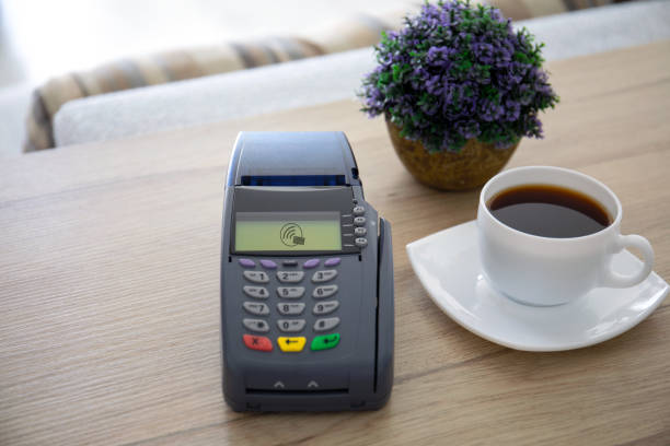 pay pass online terminal on the table in a cafe pay pass online terminal on the table in a cafe point of sale tablet stock pictures, royalty-free photos & images