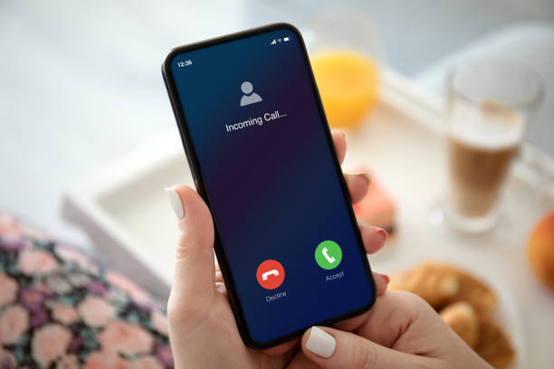 istock female hands holding phone with incoming call on the screen 1270022636