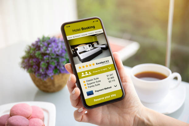 istock female hands holding phone with app hotel booking on screen 1270023486