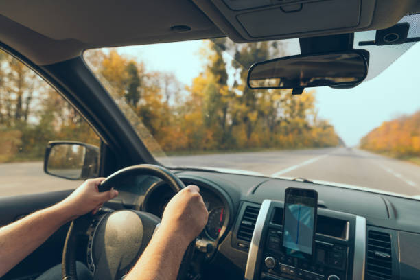 istock road trip concept man hands on steering wheel navigation on the phone 1270023519