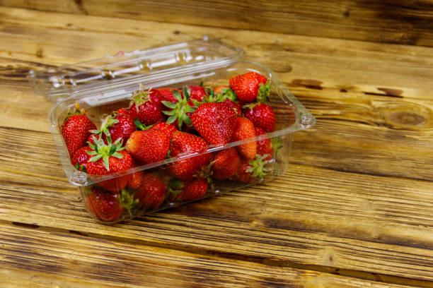 istock Fresh strawberry in plastic box on a wooden table 1270025142