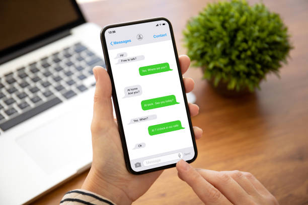 istock female hands holding phone with app messenger on the screen 1270025208