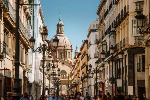 Alfonso I street in Zaragoza, Spain. El Pilar Basilica appears at the end of the street