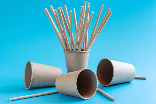 istock Disposable brown craft paper cups with paper straws on blue background. Eco-friendly tableware. No plastic and zero waste concept. 1270027503
