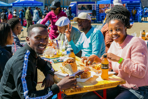 Diverse African people at a bread based street food outdoor festival Soweto, South Africa - September 8, 2018: Diverse African people at a bread based street food outdoor festival johannesburg photos stock pictures, royalty-free photos & images