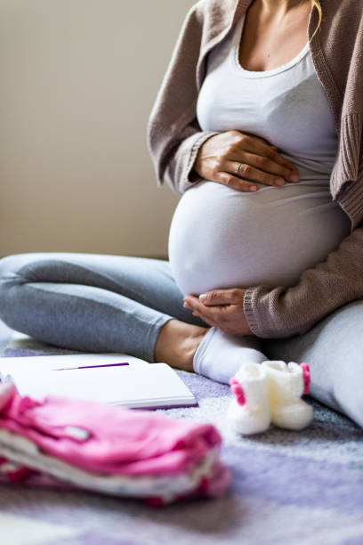 istock Pregnant woman making to do list 1270031868