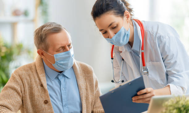 istock Doctor and senior couple wearing facemasks 1270032198