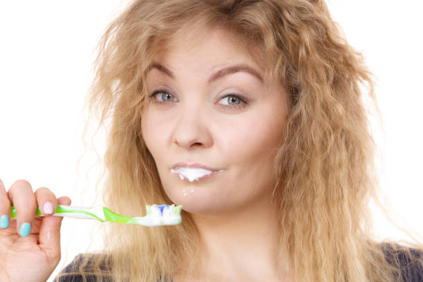 istock Woman brushing cleaning teeth 1270032201