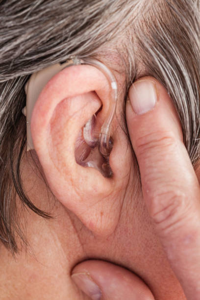 istock Closeup senior woman using hearing aid 1270032256