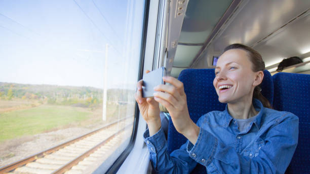 istock beautiful girl traveling by train and using phone looking 1270032296