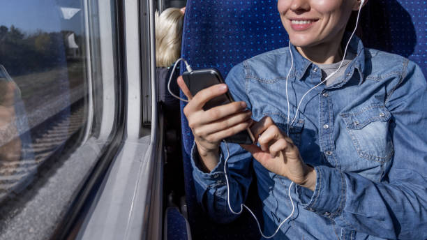 istock beautiful girl traveling by train and using phone looking 1270032503