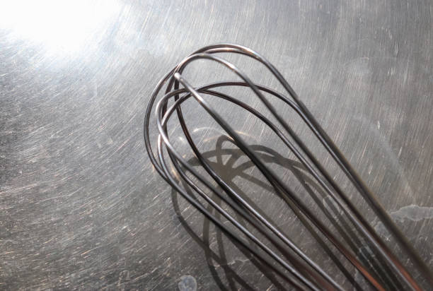istock Manual hand mixer for blending, beating, Egg beater isolated on metal background. Metal stainless steel kitchenware utensil. 1270032945
