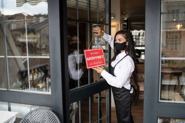 istock Open sign in a small restaurant or cafe after Coronavirus pandemic 1270033021