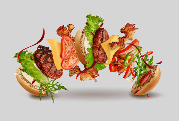 istock Burger with flying ingredients against gray background. Ham, beef cutlet, cheese, ketchup, mayonnaise, vegetables and greens. Close up, copy space 1270033190