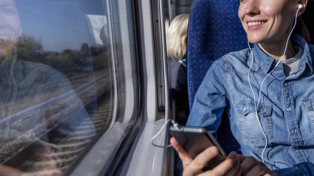 istock beautiful girl traveling by train and using phone looking 1270033502