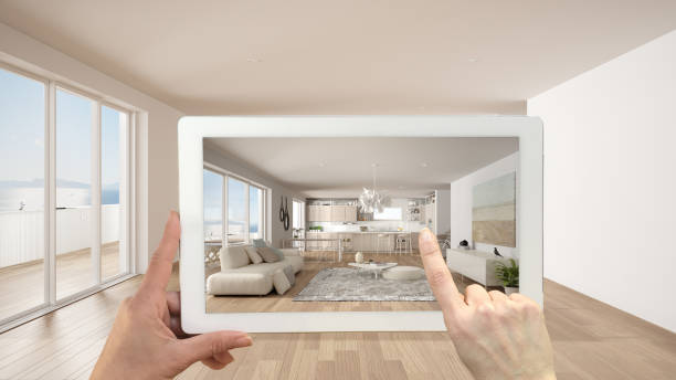 istock Augmented reality concept. Hand holding tablet with AR application used to simulate furniture and design products in empty interior with ceramic floor, modern white kitchen 1270034915